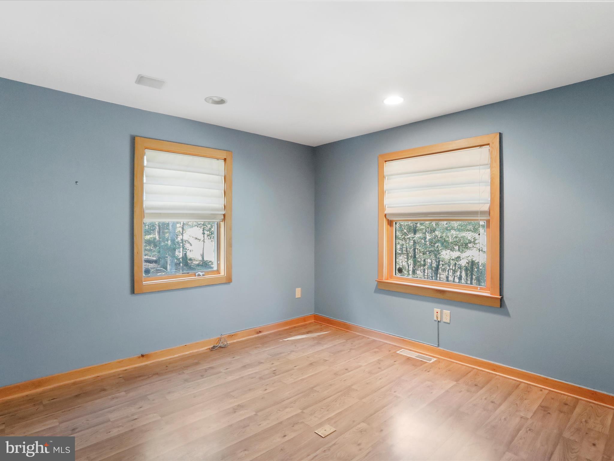 1580 Gaither Road Great Cacapon, WV 25422 - Photo 19 of 65 a view of an empty room with wooden floor and a window
