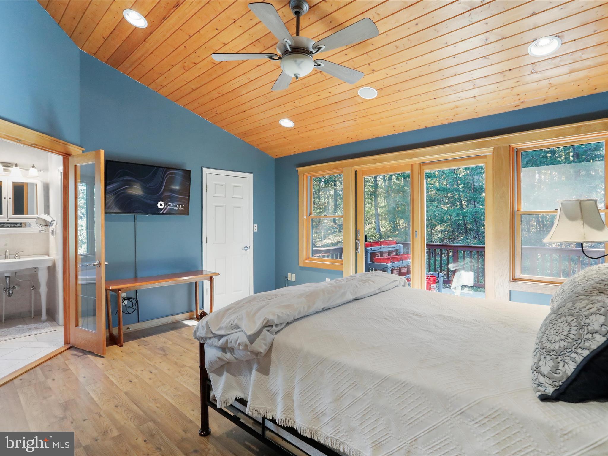 1580 Gaither Road Great Cacapon, WV 25422 - Photo 23 of 65 a bedroom with a large bed and a large window