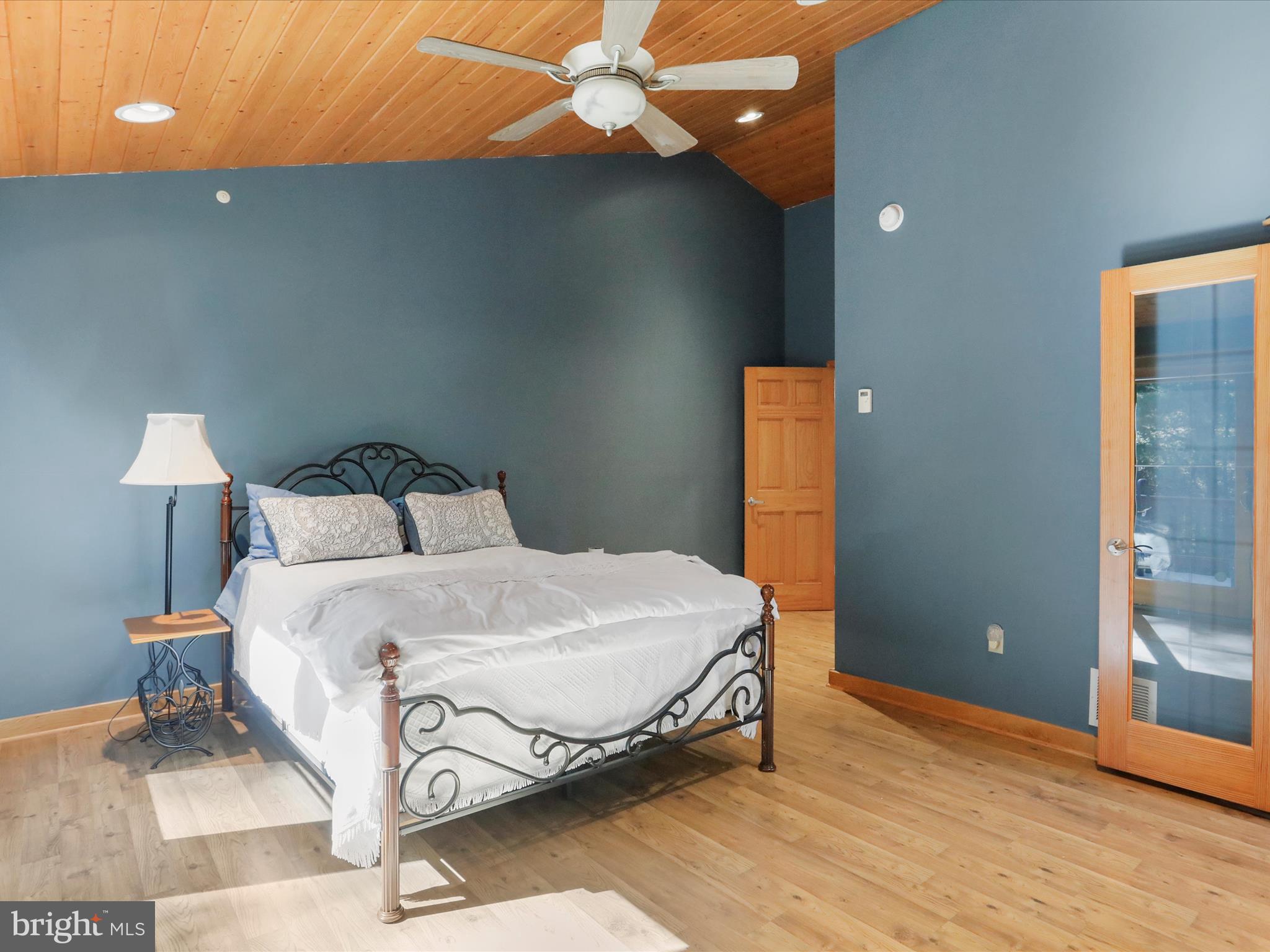 1580 Gaither Road Great Cacapon, WV 25422 - Photo 24 of 65 a bedroom with a bed and a lamp