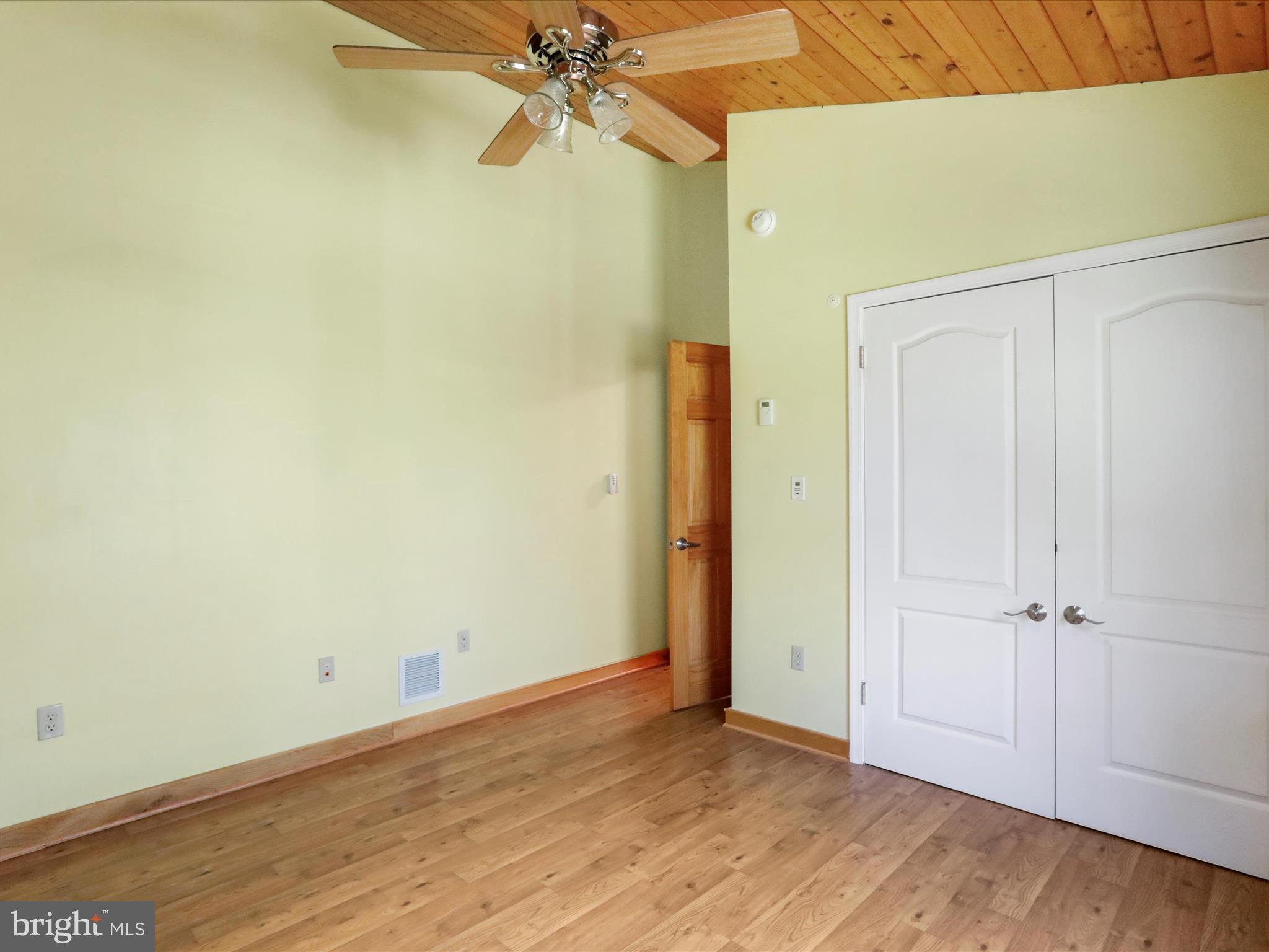 1580 Gaither Road Great Cacapon, WV 25422 - Photo 29 of 65 an empty room with wooden floor closet and fan