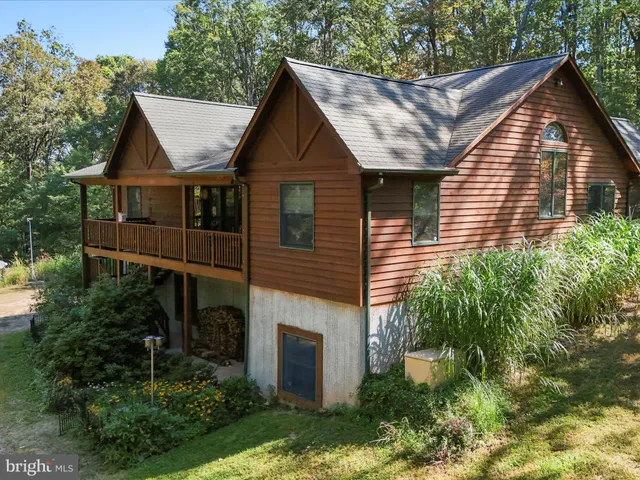 a front view of house with a garden