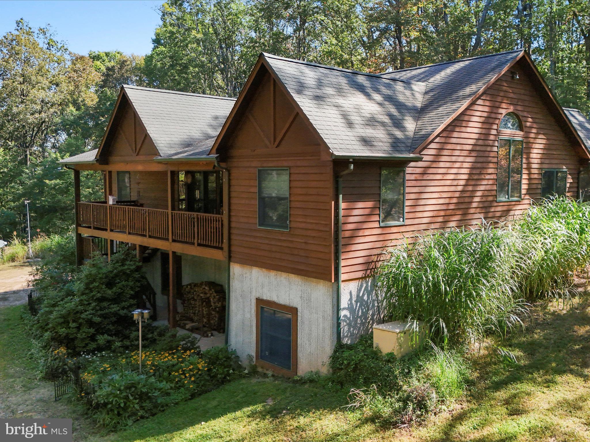 1580 Gaither Road Great Cacapon, WV 25422 - Photo 3 of 65 a front view of house with a garden
