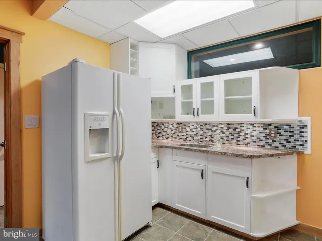 a bathroom with a toilet mirror and vanity