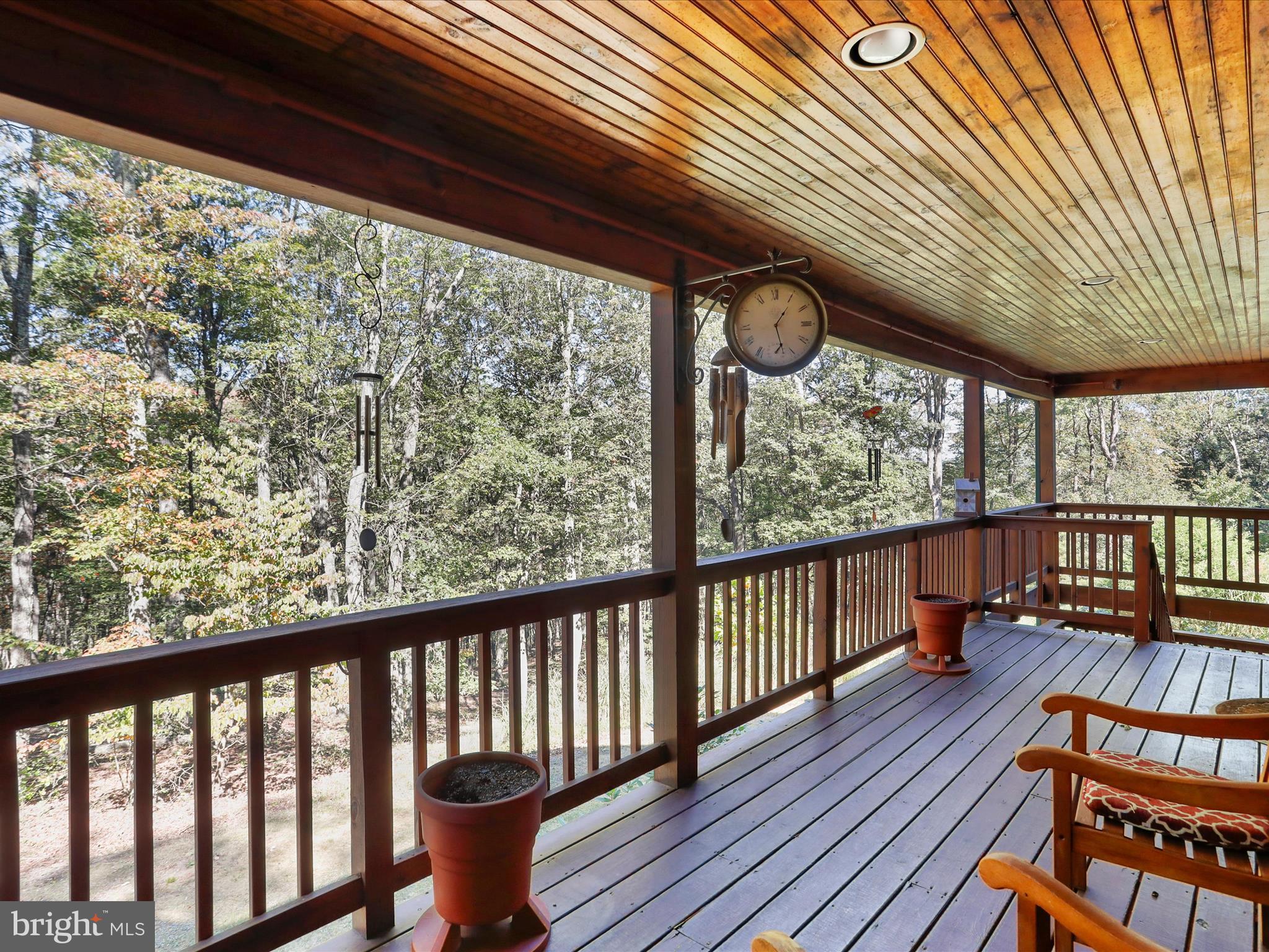 1580 Gaither Road Great Cacapon, WV 25422 - Photo 4 of 65 a view of a porch with wooden floor
