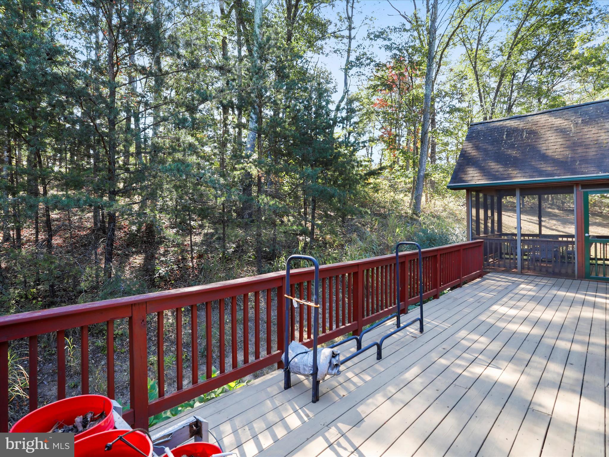 1580 Gaither Road Great Cacapon, WV 25422 - Photo 43 of 65 a balcony with wooden floor and trees in the back