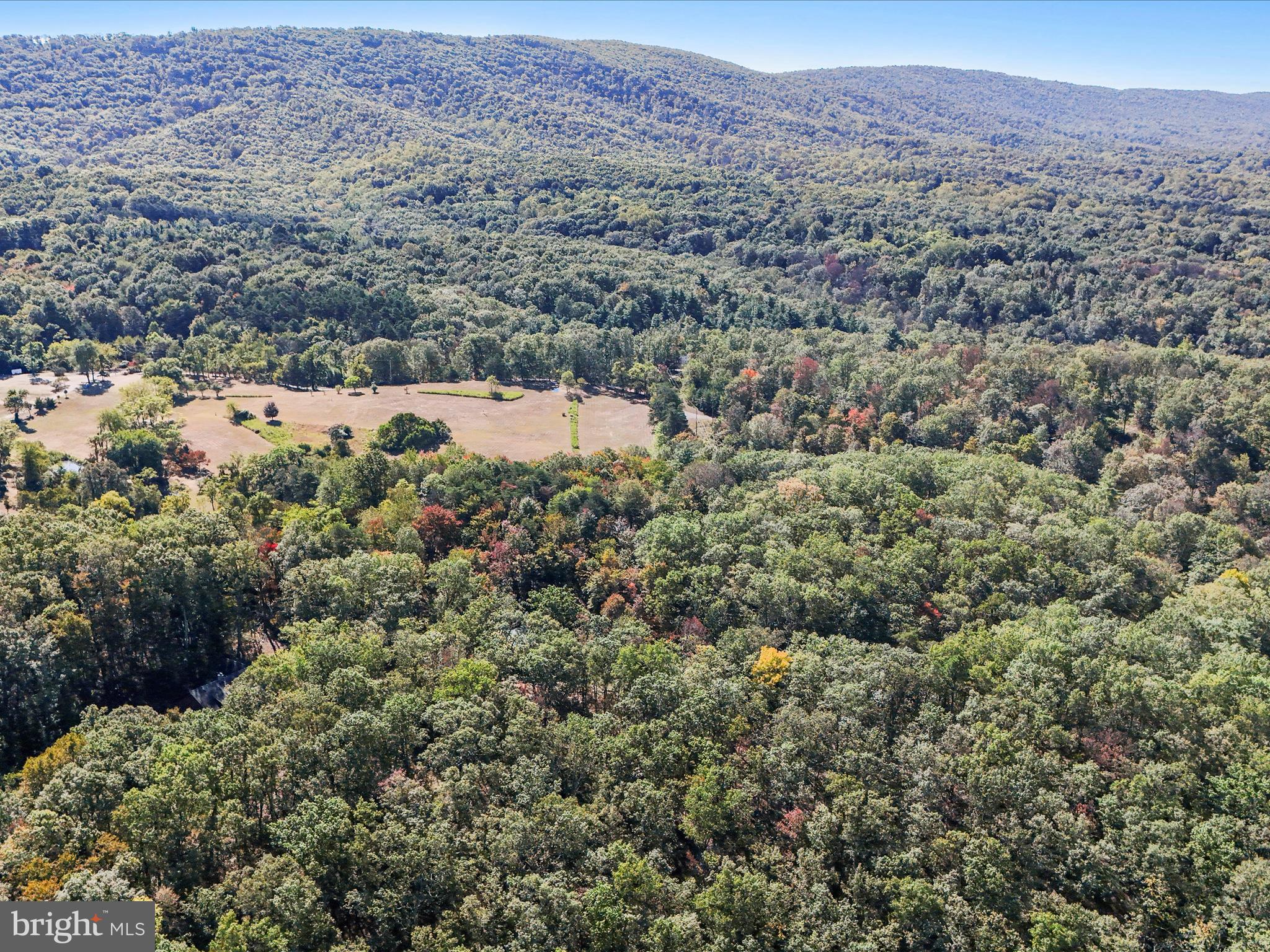 1580 Gaither Road Great Cacapon, WV 25422 - Photo 55 of 65 an aerial view of house with yard and mountain view in back