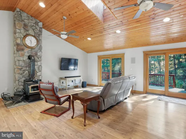 a living room with furniture kitchen view and a large window