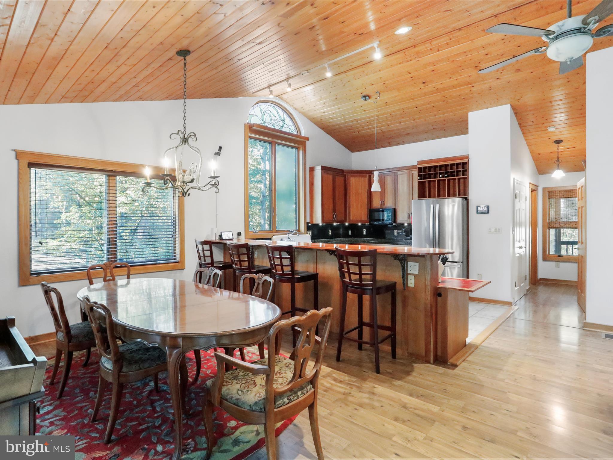 1580 Gaither Road Great Cacapon, WV 25422 - Photo 10 of 65 a dining room with furniture a chandelier and wooden floor