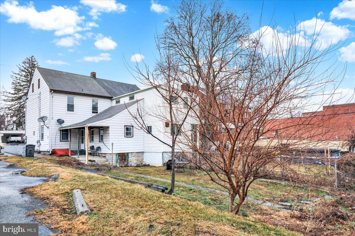 746 Maple Street Lebanon, PA 17046 - Photo 20 of 21 a view of a white house next to a yard with a large tree