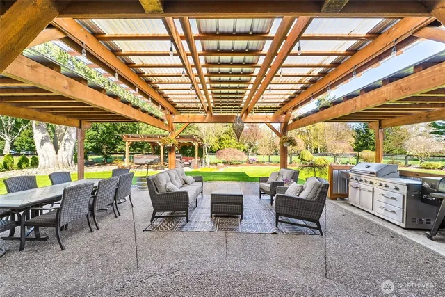 a view of an outdoor dining space with furniture and garden view