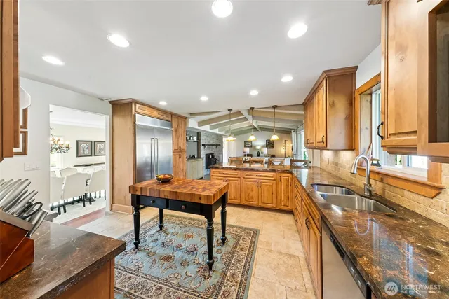 a living room with stainless steel appliances kitchen island granite countertop furniture and a kitchen view
