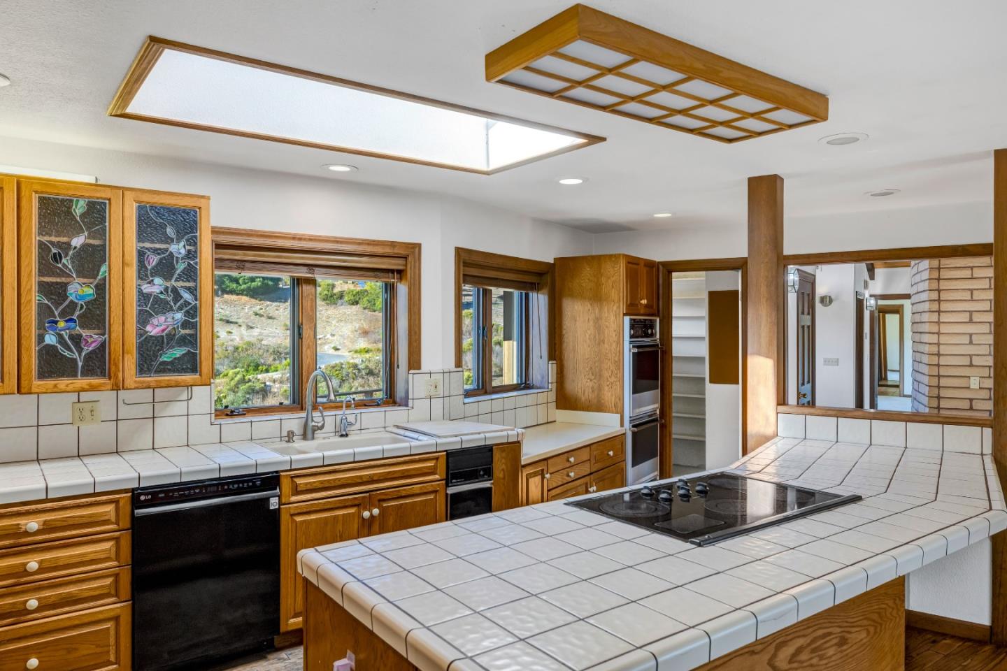 274 Corral De Tierra Road Salinas, CA 93908 - Photo 11 of 46 a kitchen with a sink and large windows