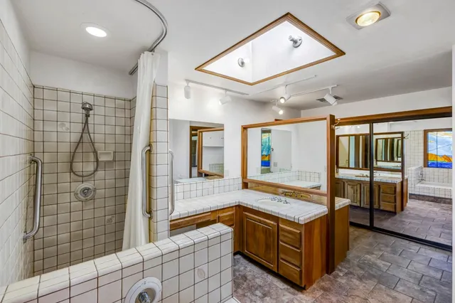 a bathroom with a bathtub and a shower