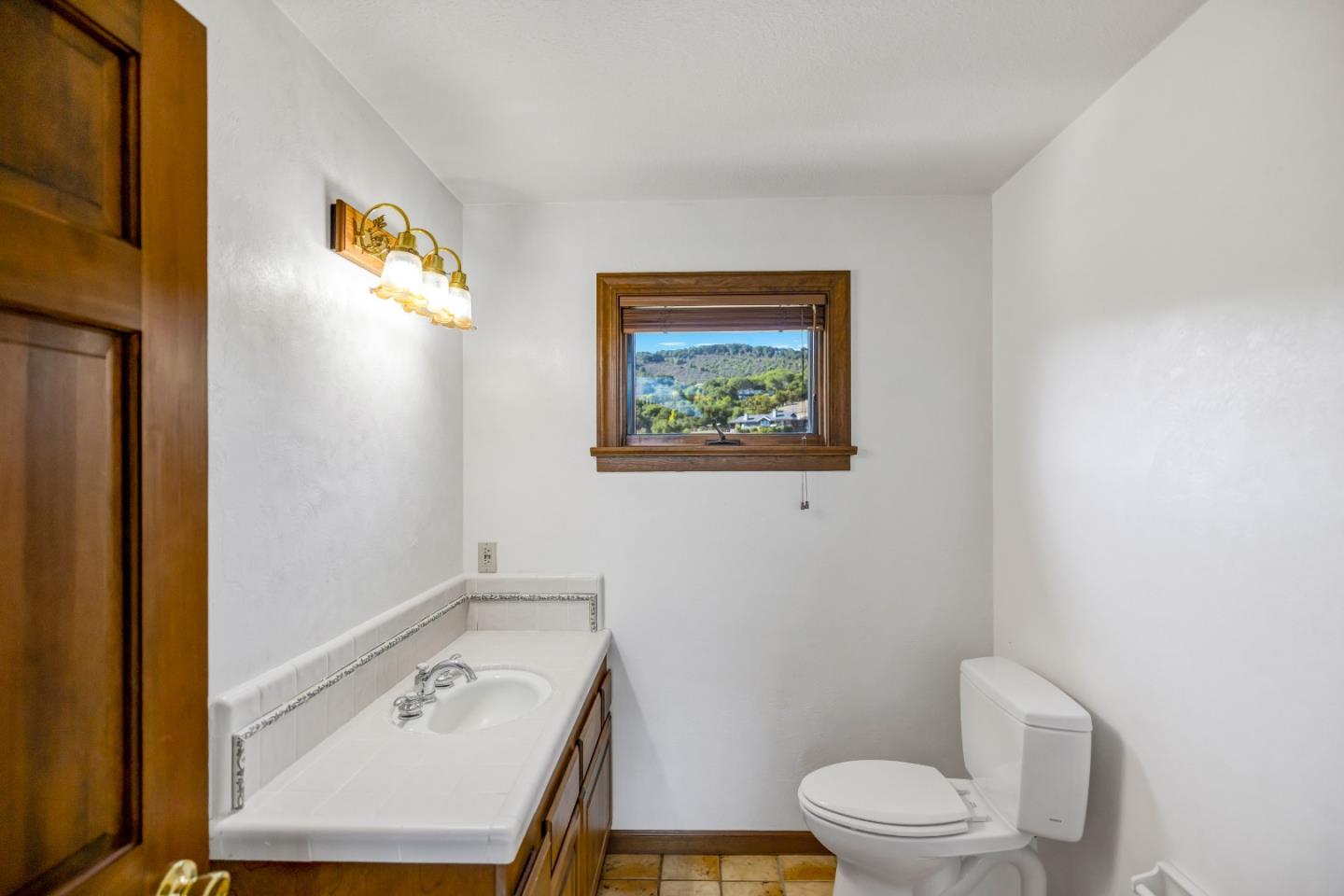 274 Corral De Tierra Road Salinas, CA 93908 - Photo 20 of 46 a bathroom with a sink mirror vanity and toilet