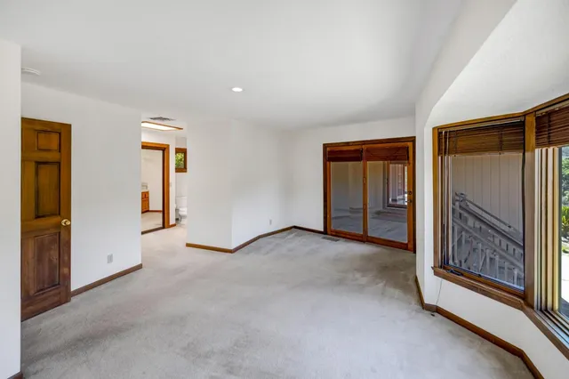 an empty room with windows and view