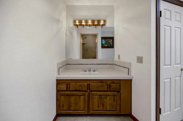 a view of an empty room with a window and fireplace