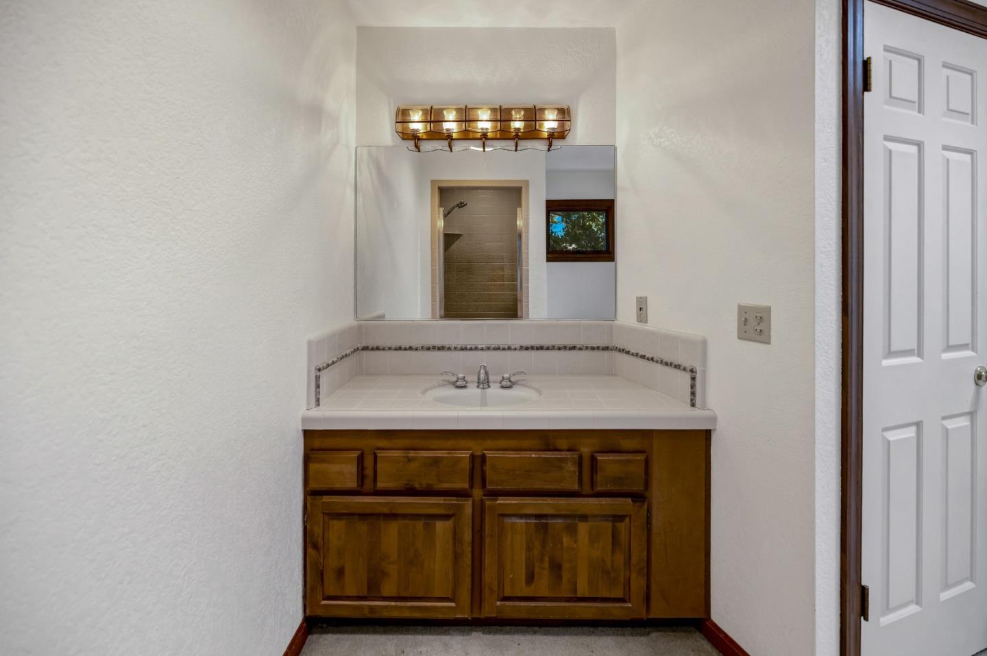 274 Corral De Tierra Road Salinas, CA 93908 - Photo 24 of 46 a bathroom with a sink and a mirror