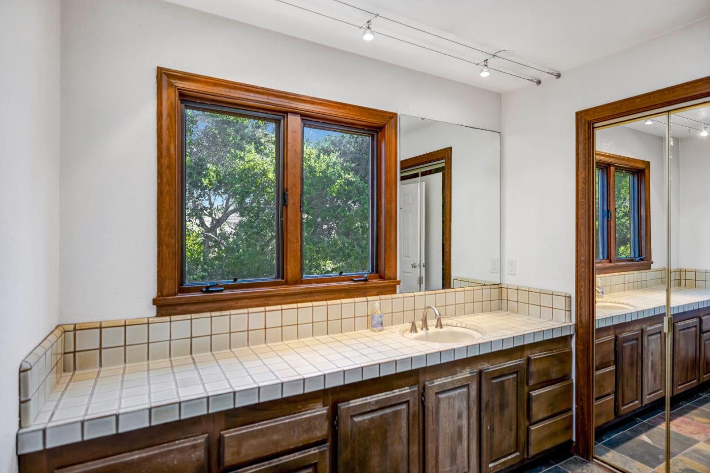 274 Corral De Tierra Road Salinas, CA 93908 - Photo 30 of 46 a bathroom with a granite countertop sink and a window