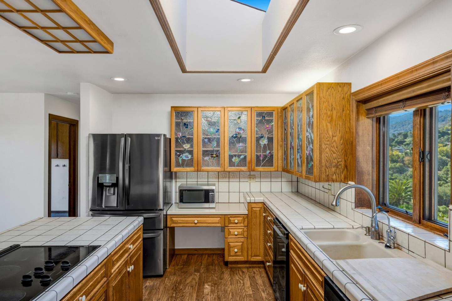 274 Corral De Tierra Road Salinas, CA 93908 - Photo 10 of 46 a kitchen with stainless steel appliances granite countertop a sink and wooden cabinets