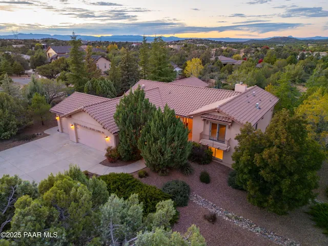 an aerial view of a house with garden space and outdoor seating