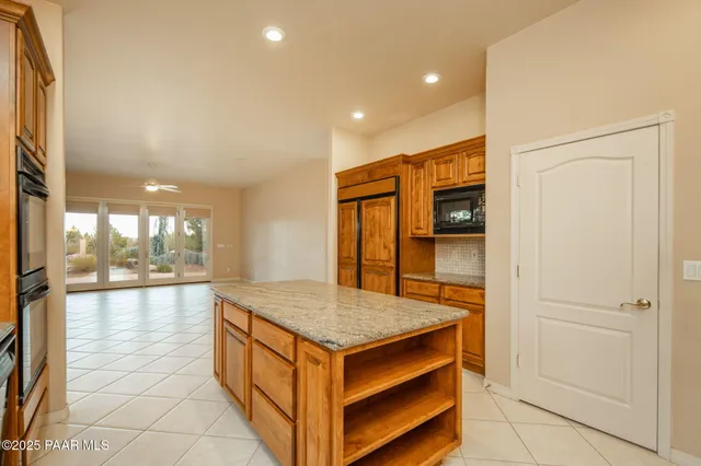 a view of a livingroom with a furniture and ceiling fan