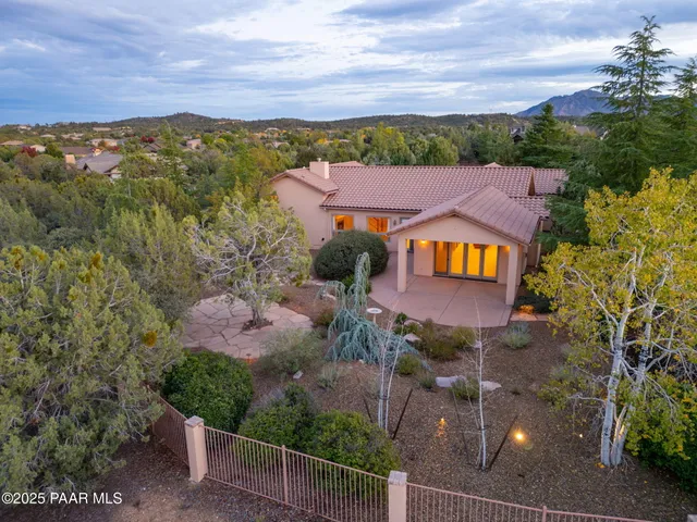 a view of a house with a yard and a street