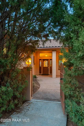 a view of a house with a tree in front of it