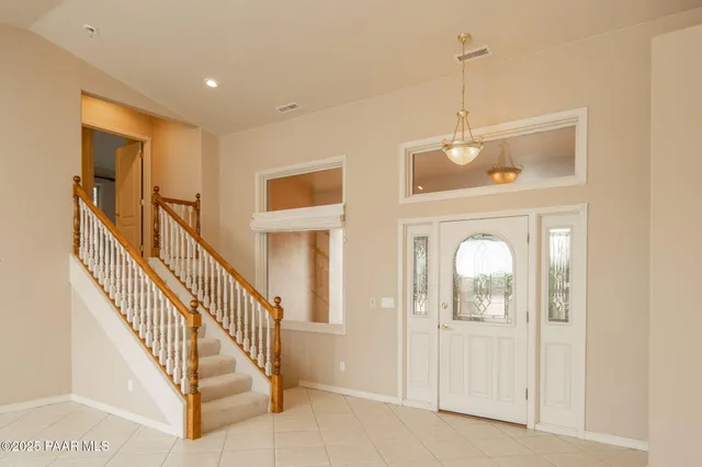 a view of a hallway with windows and entryway