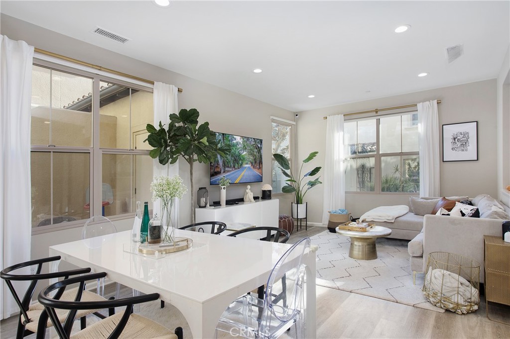 128 Nature Walk Irvine, CA 92618 - Photo 6 of 24 a living room with furniture and potted plant