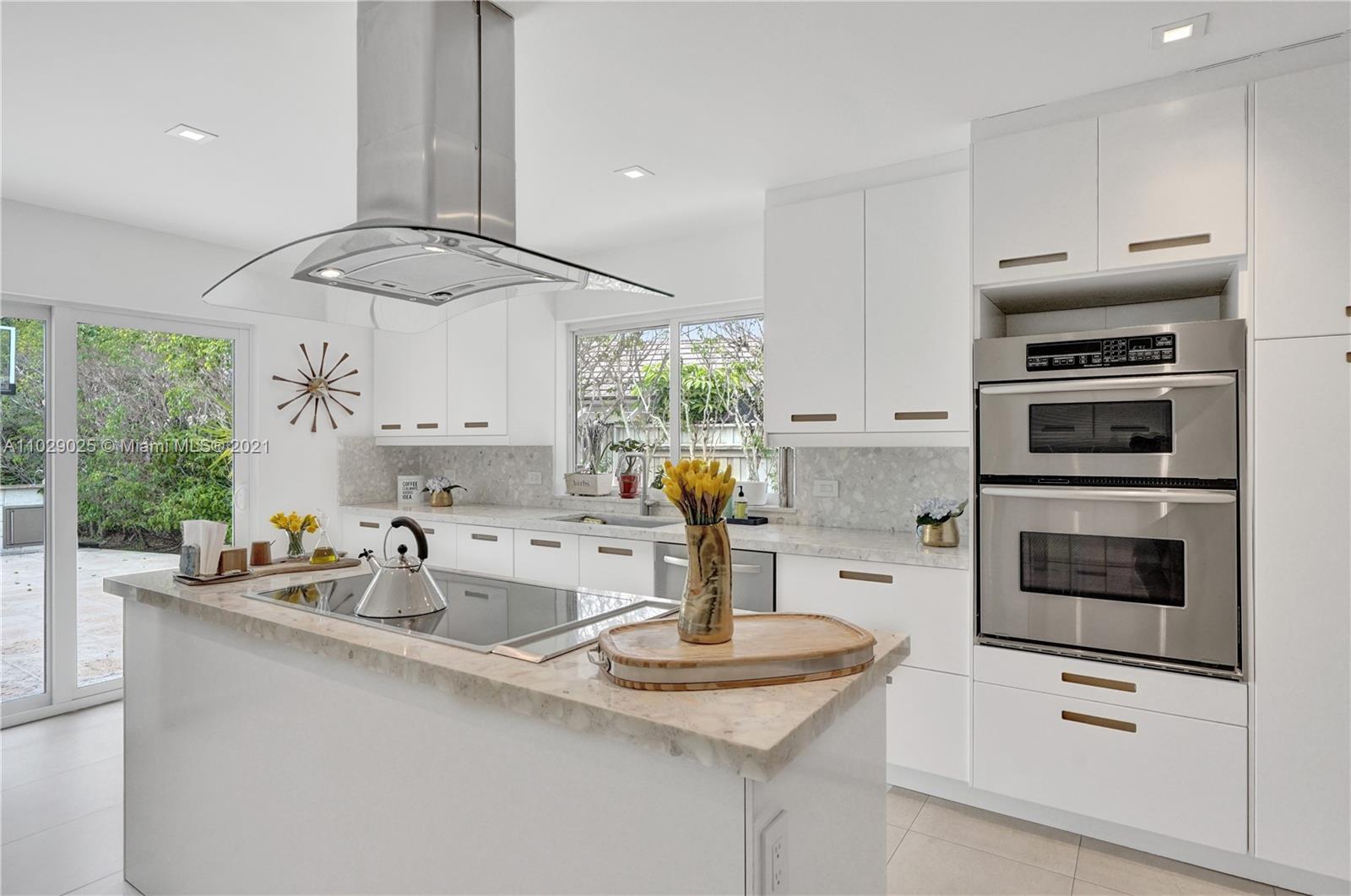 4425 Island Road Miami, FL 33137 - Photo 12 of 30 a kitchen with stainless steel appliances a sink a stove and cabinets