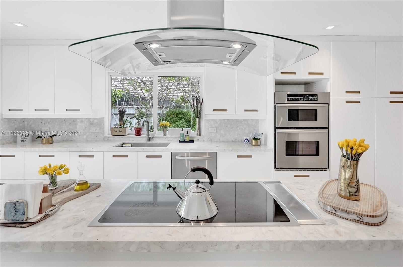 4425 Island Road Miami, FL 33137 - Photo 14 of 30 a kitchen with a sink appliances and cabinets