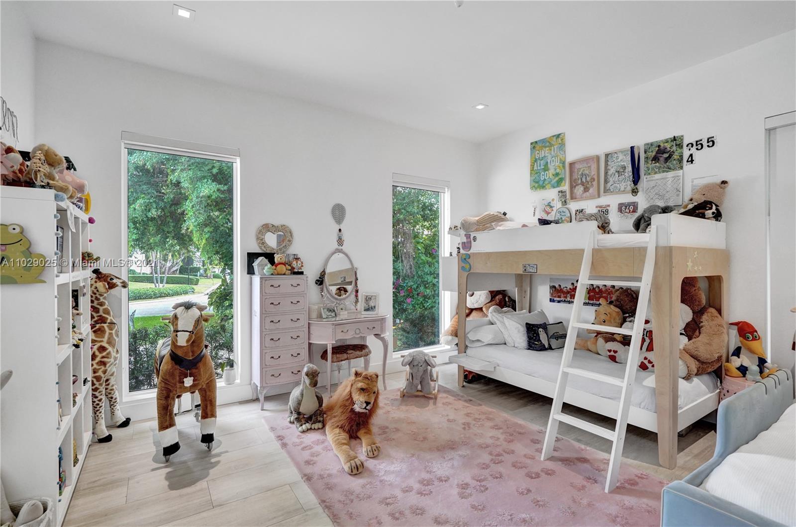 4425 Island Road Miami, FL 33137 - Photo 23 of 30 a bedroom with furniture a fireplace and windows