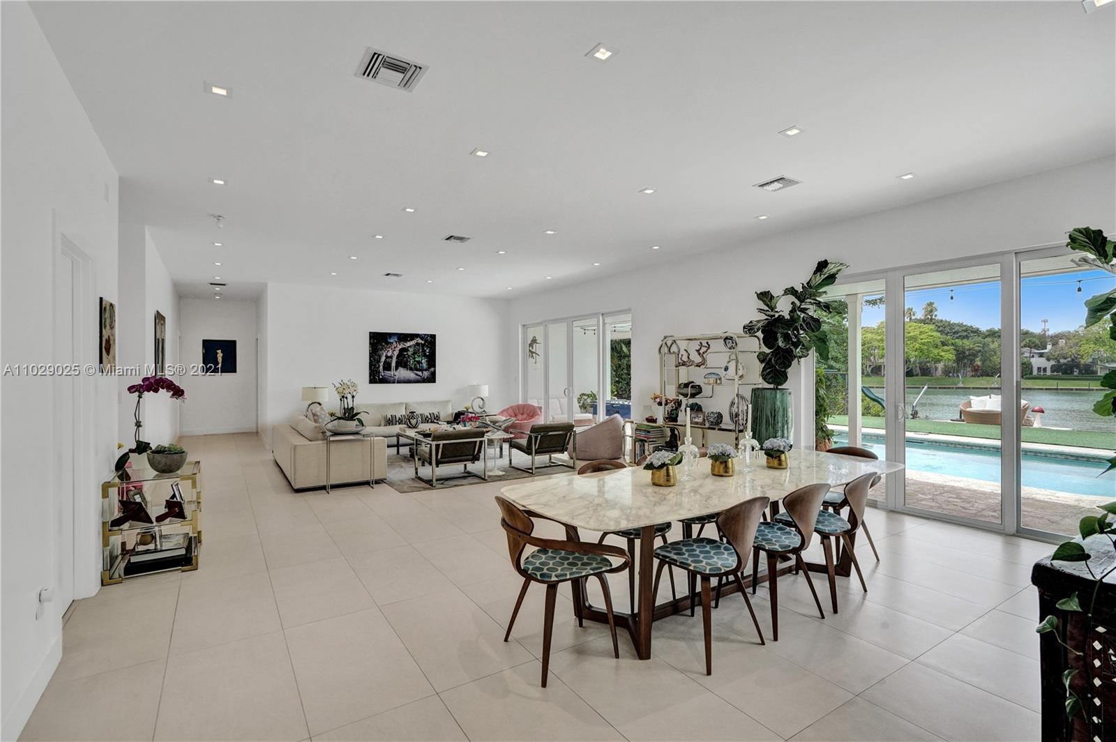 4425 Island Road Miami, FL 33137 - Photo 7 of 30 a view of a dining room with furniture and a floor to ceiling window