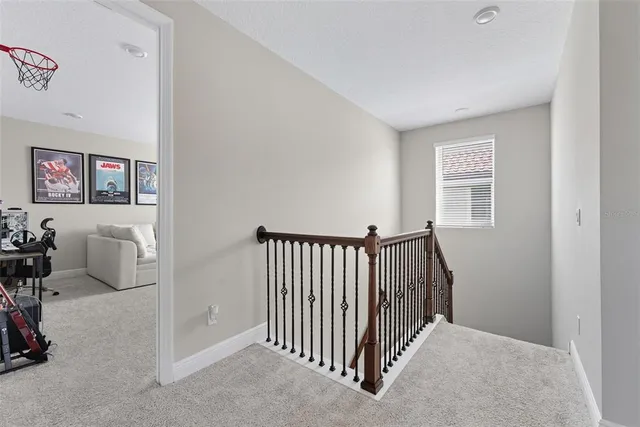 a living room with furniture and a book shelf