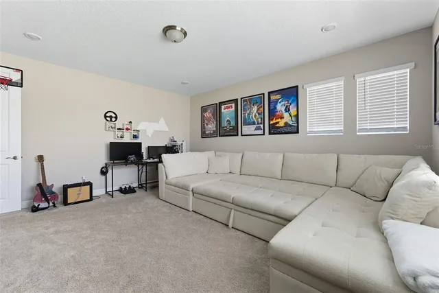 a bedroom with bed couch and window