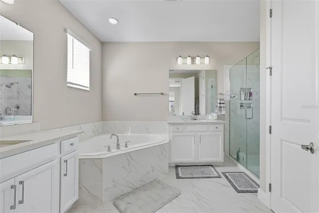 a bathroom with a shower a sink and mirror