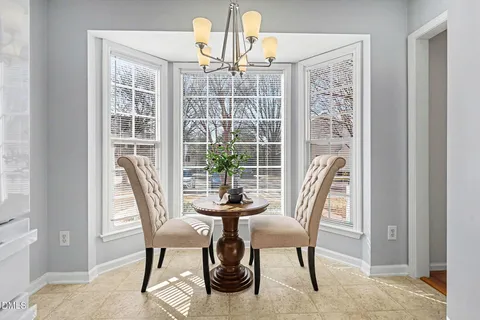 a view of a hallway with furniture and windows
