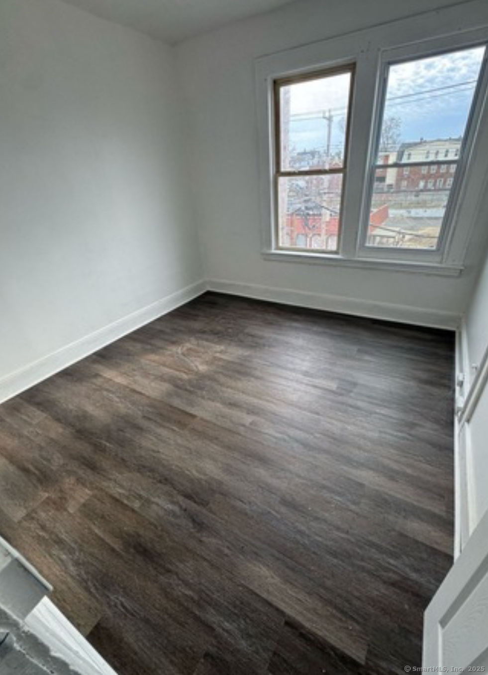 159 Charles Street, Unit 8 Bridgeport, CT 06606 - Photo 2 of 2 an empty room with two windows