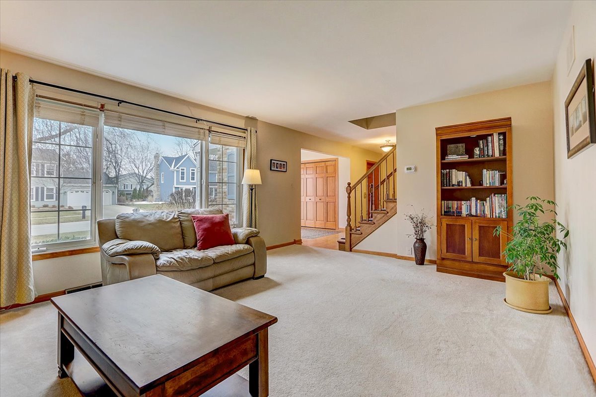 827 Manchester Street Naperville, IL 60563 - Photo 11 of 48 a living room with furniture and a large window