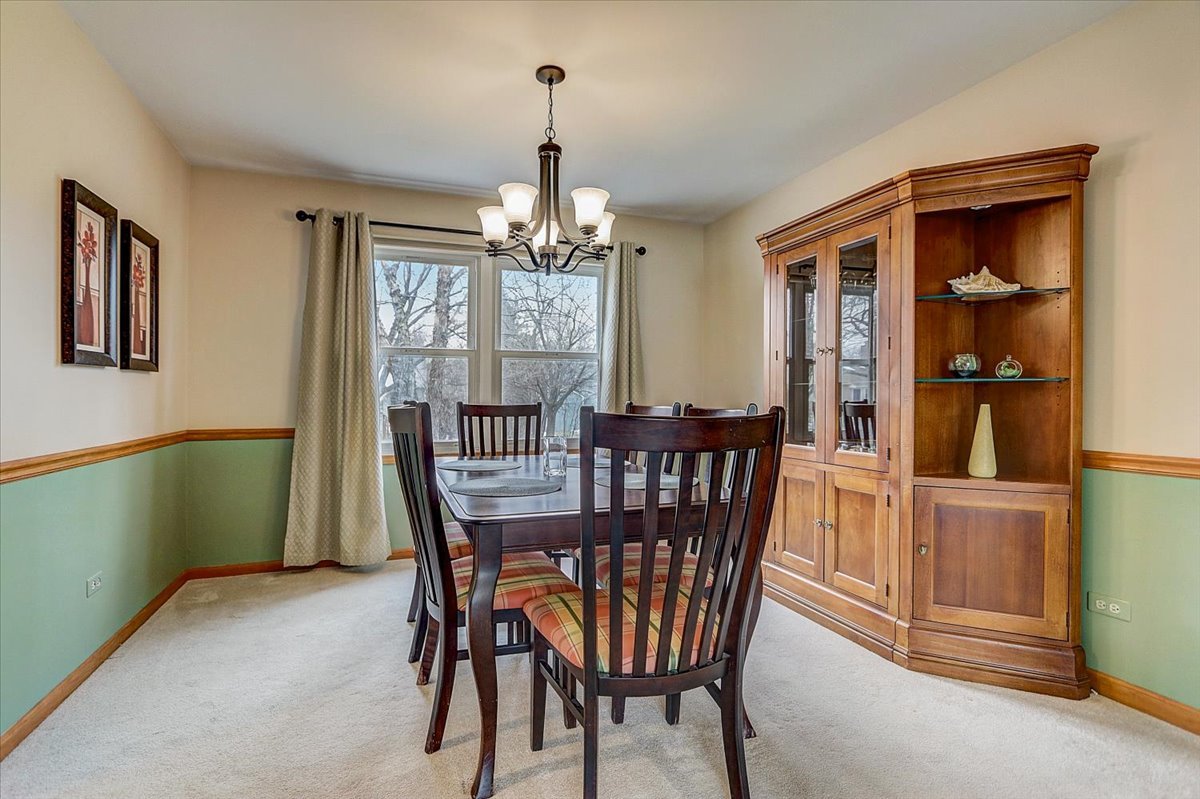 827 Manchester Street Naperville, IL 60563 - Photo 15 of 48 a view of a dining room with furniture window and wooden floor