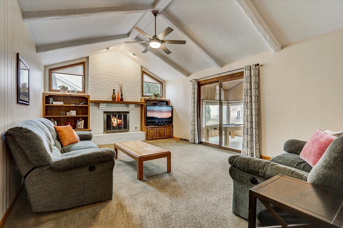 827 Manchester Street Naperville, IL 60563 - Photo 2 of 48 a living room with furniture and a fireplace
