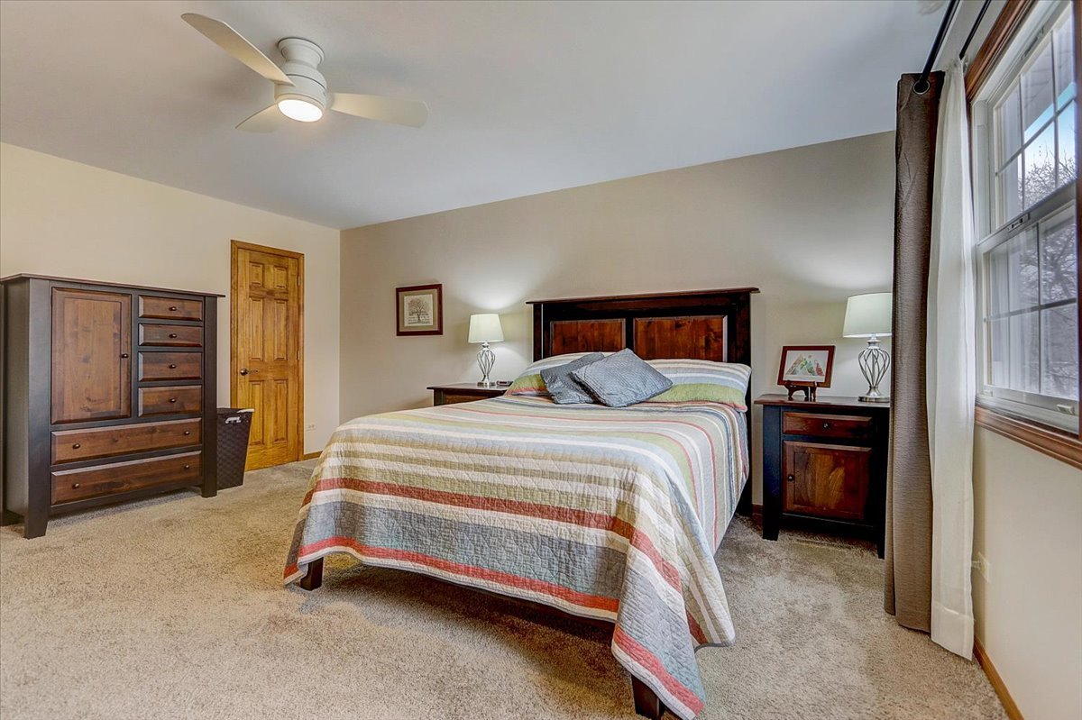 827 Manchester Street Naperville, IL 60563 - Photo 23 of 48 a bedroom with a bed and a walk in closet