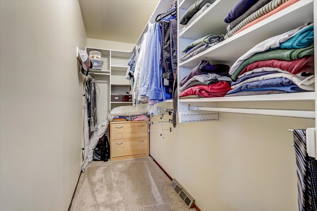 827 Manchester Street Naperville, IL 60563 - Photo 25 of 48 a view of walk in closet with clothes and shoes