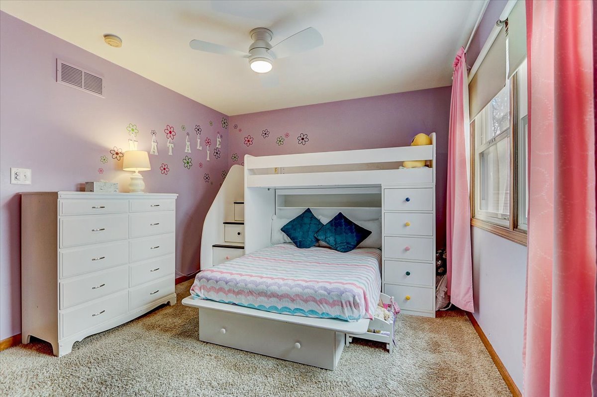 827 Manchester Street Naperville, IL 60563 - Photo 28 of 48 a bedroom with a bed and a dresser