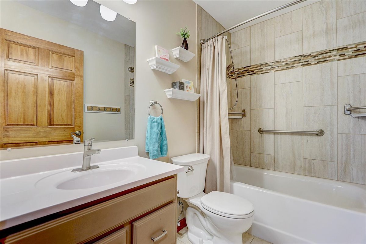 827 Manchester Street Naperville, IL 60563 - Photo 30 of 48 a bathroom with a sink a toilet and a mirror