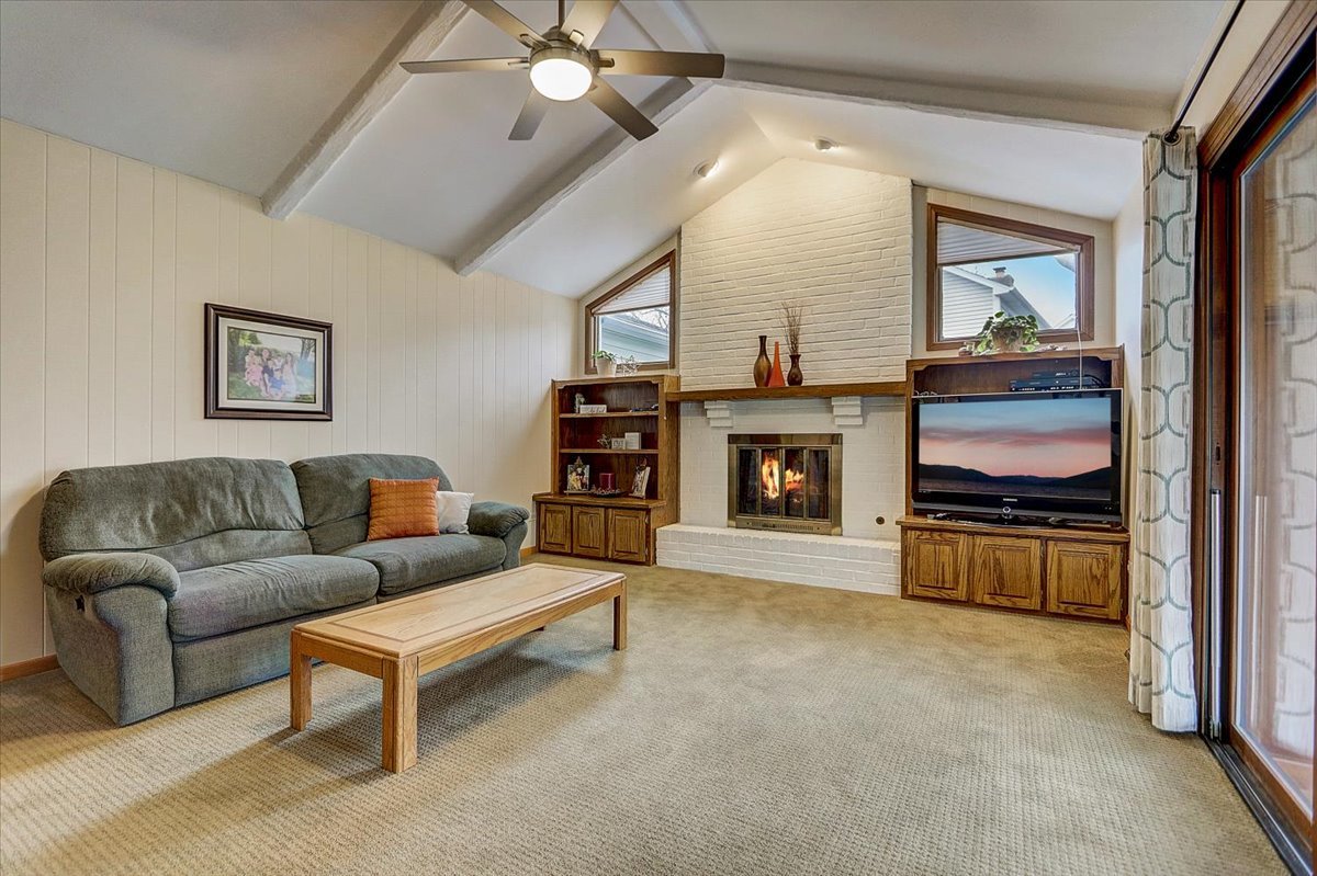 827 Manchester Street Naperville, IL 60563 - Photo 3 of 48 a living room with furniture and a fireplace