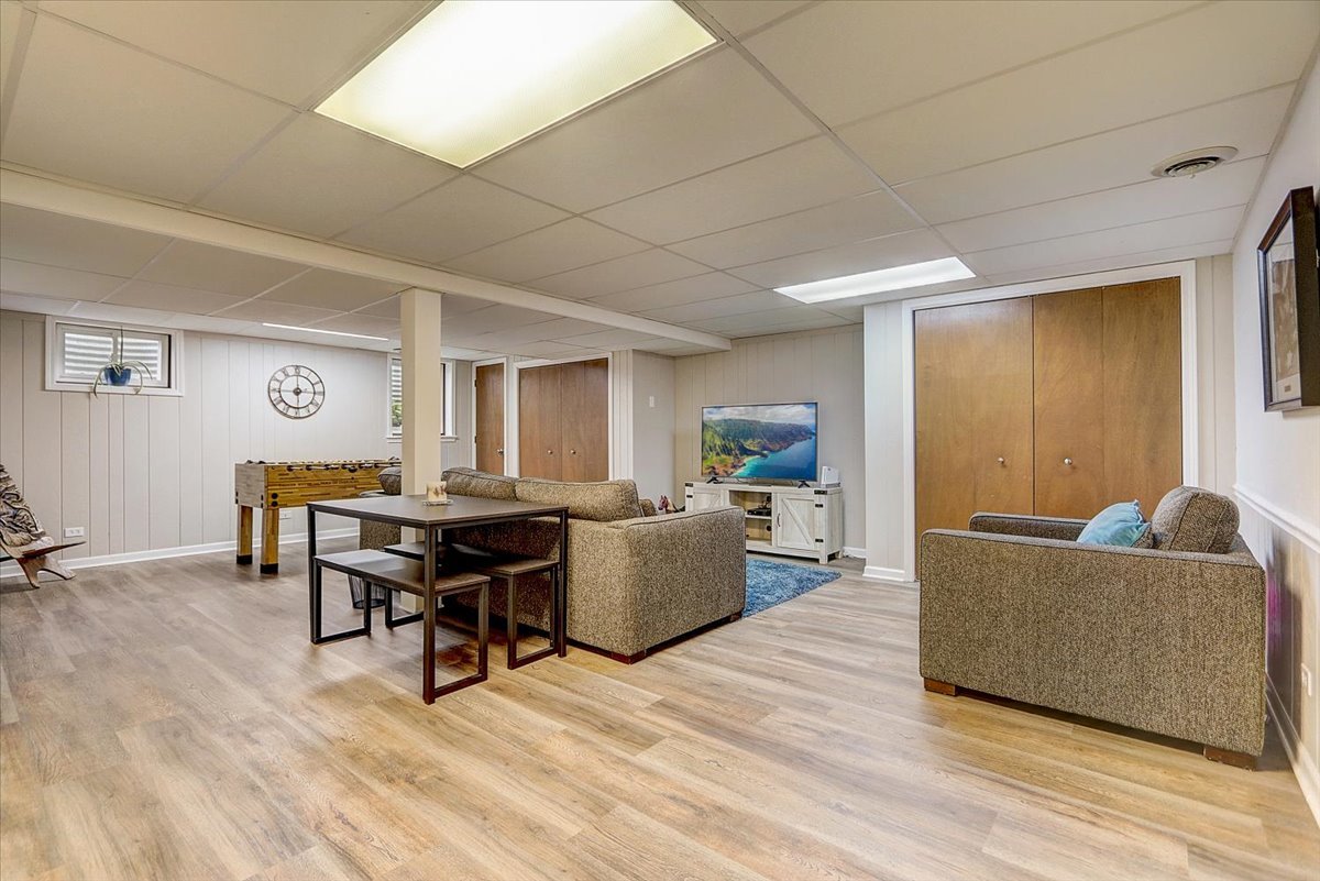 827 Manchester Street Naperville, IL 60563 - Photo 35 of 48 a living room with furniture and a wooden floor