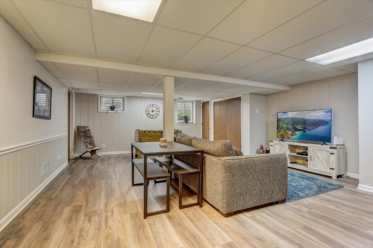 827 Manchester Street Naperville, IL 60563 - Photo 36 of 48 a living room with furniture and a flat screen tv