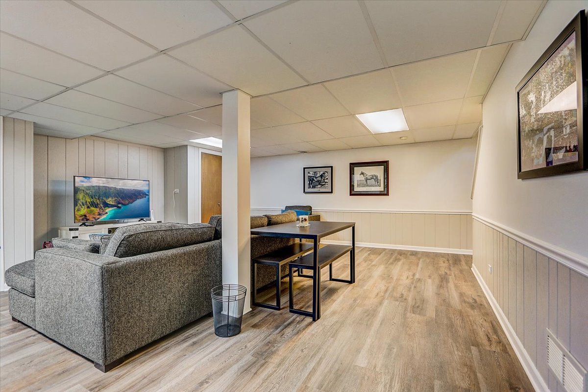 827 Manchester Street Naperville, IL 60563 - Photo 37 of 48 a living room with furniture and a wooden floor