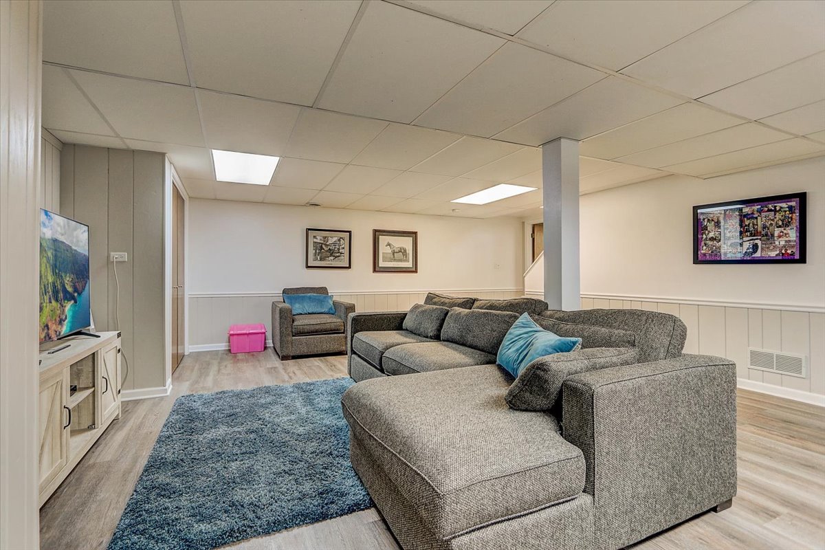 827 Manchester Street Naperville, IL 60563 - Photo 38 of 48 a living room with furniture and a flat screen tv